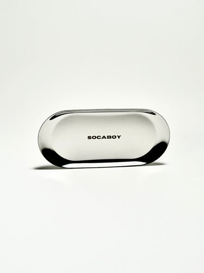 The Socaboy Rolland Tray in chrome is photographed against a white backdrop. The tray features the logo engraved in the centre.
